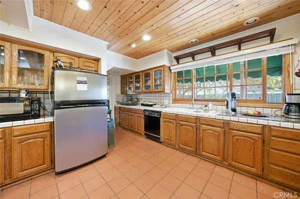 a kitchen with granite countertop stainless steel appliances a sink and cabinets