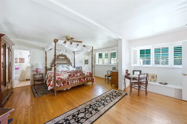 a bedroom with furniture and a wooden floor