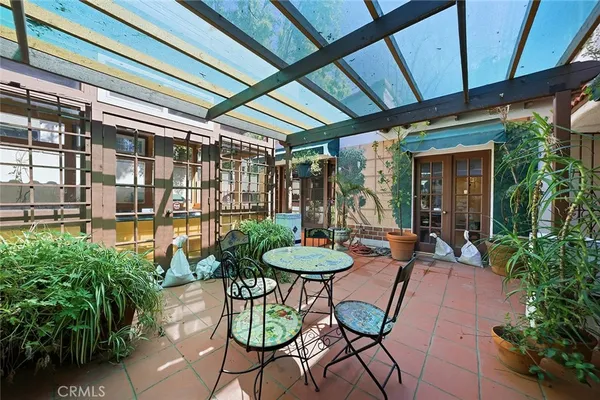 a patio with yard and outdoor seating