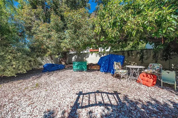 a view of a backyard with wooden fence
