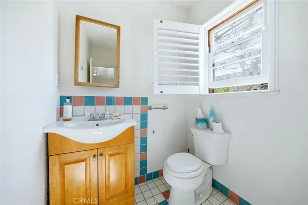 a bathroom with a sink toilet and mirror