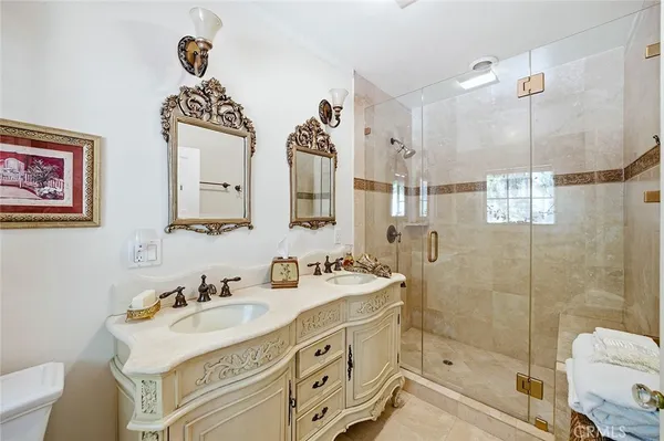 a bathroom with a sink mirror and a shower