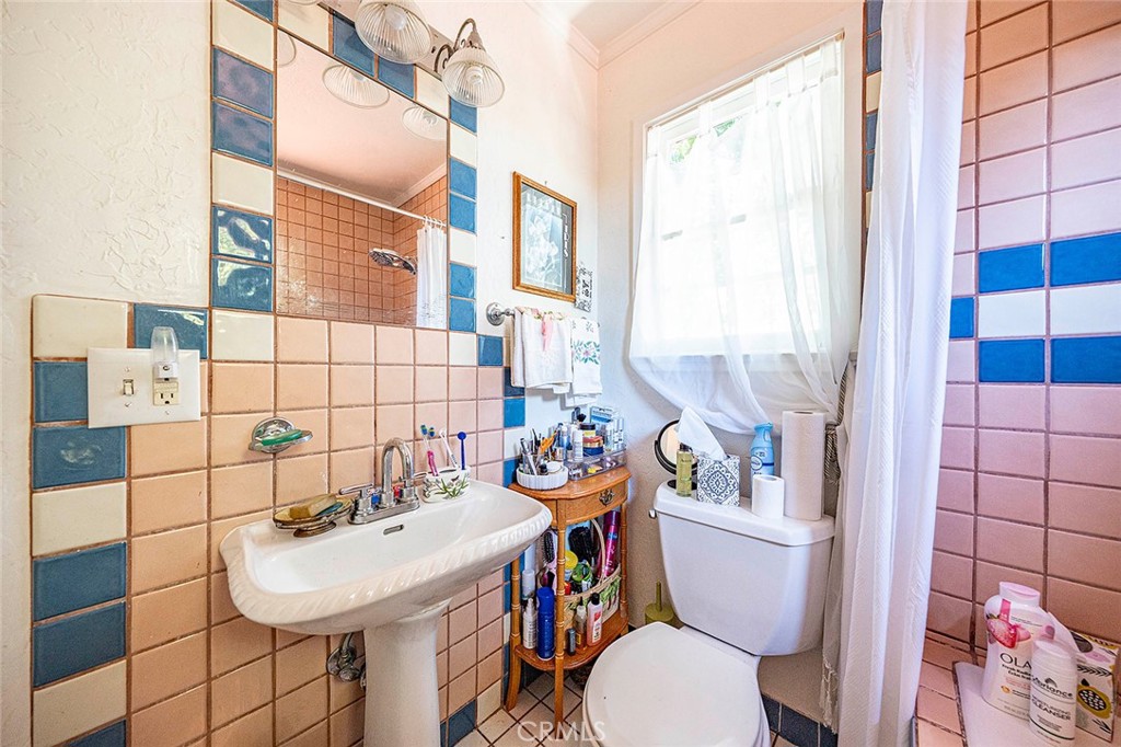 2393 Allen Avenue Altadena, CA 91001 - Photo 40 of 41 a bathroom with a sink a toilet a mirror and shower