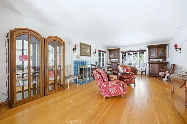 a living room with furniture a fireplace and wooden floor