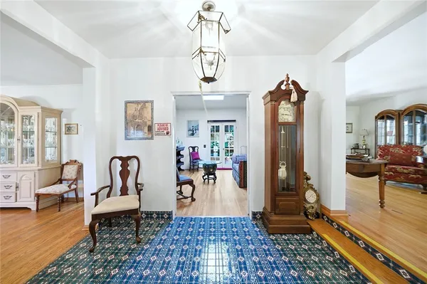a view of a hallway with dining room and wooden floor