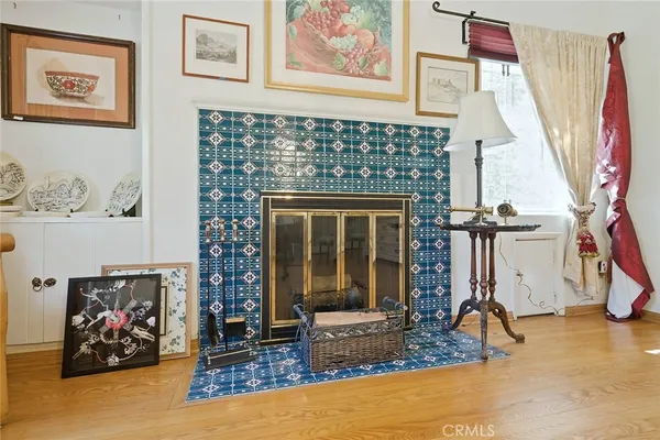 a living room with fireplace furniture and a window