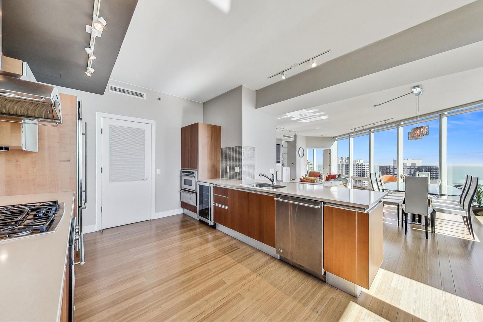 340 East Randolph Street, Unit 4901 Chicago, IL 60601 - Photo 11 of 50 a kitchen with lots of counter top space and appliances