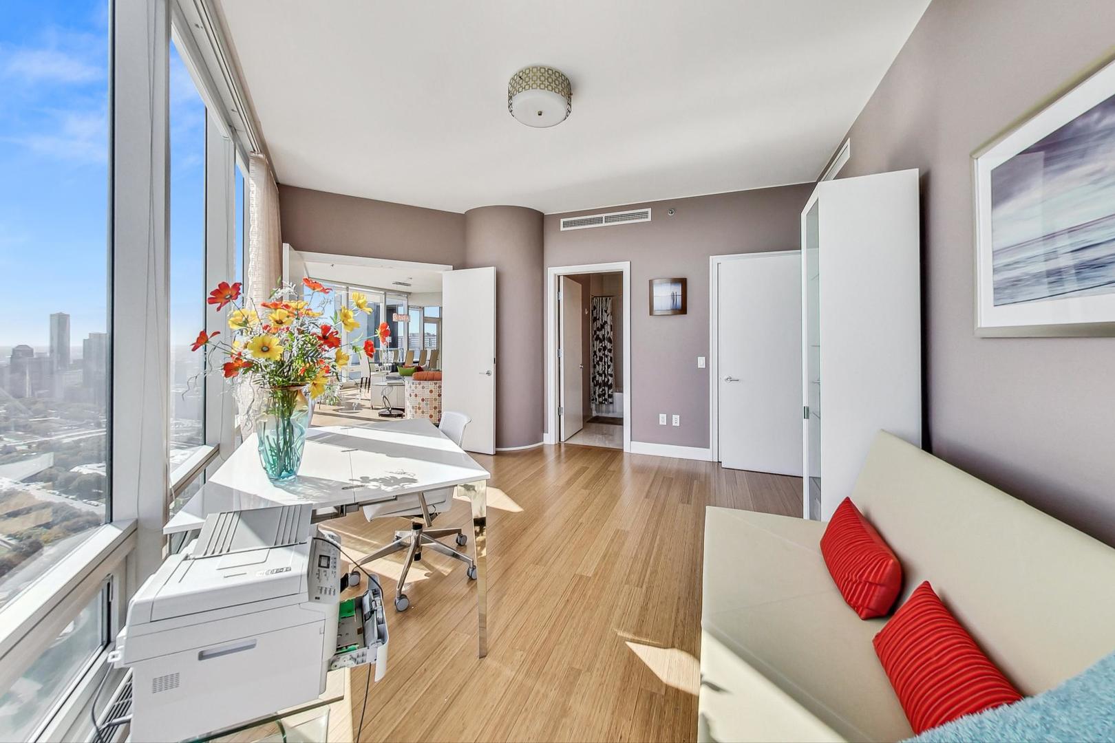 340 East Randolph Street, Unit 4901 Chicago, IL 60601 - Photo 20 of 50 a living room with furniture and flowers