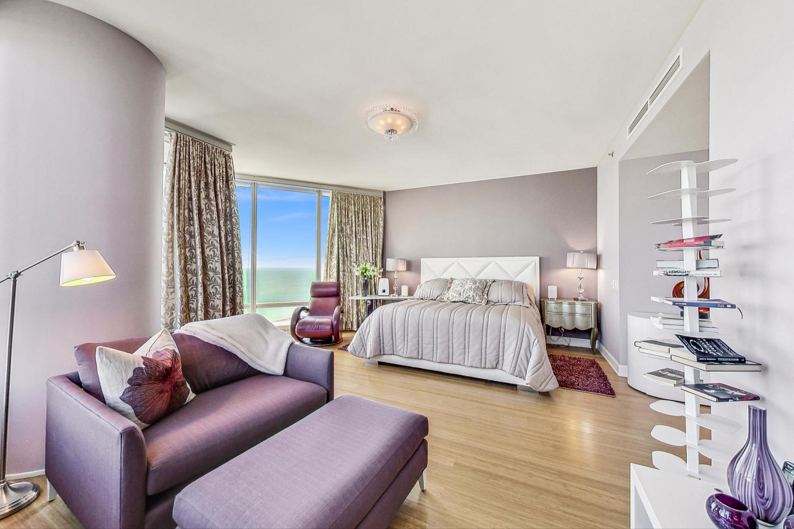 340 East Randolph Street, Unit 4901 Chicago, IL 60601 - Photo 23 of 50 a bedroom with a bed couch and a window