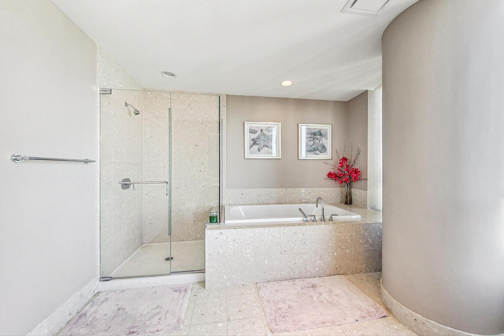 340 East Randolph Street, Unit 4901 Chicago, IL 60601 - Photo 26 of 50 a bathroom with a tub shower and a mirror