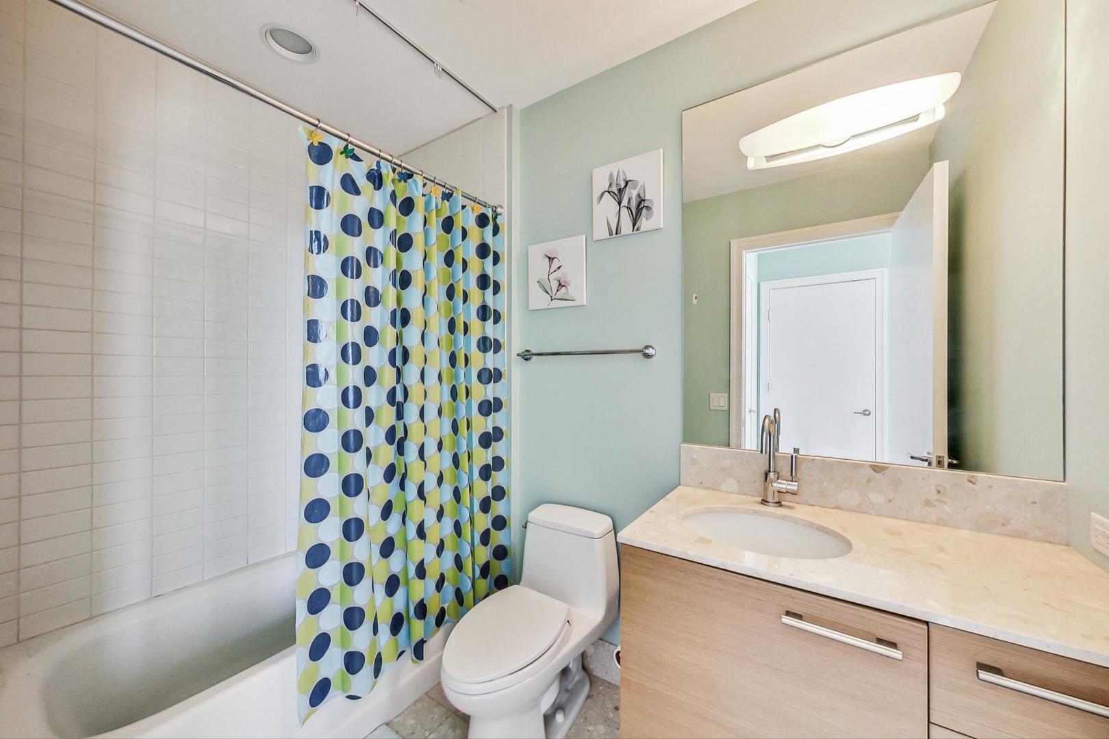 340 East Randolph Street, Unit 4901 Chicago, IL 60601 - Photo 32 of 50 a bathroom with a sink toilet and shower