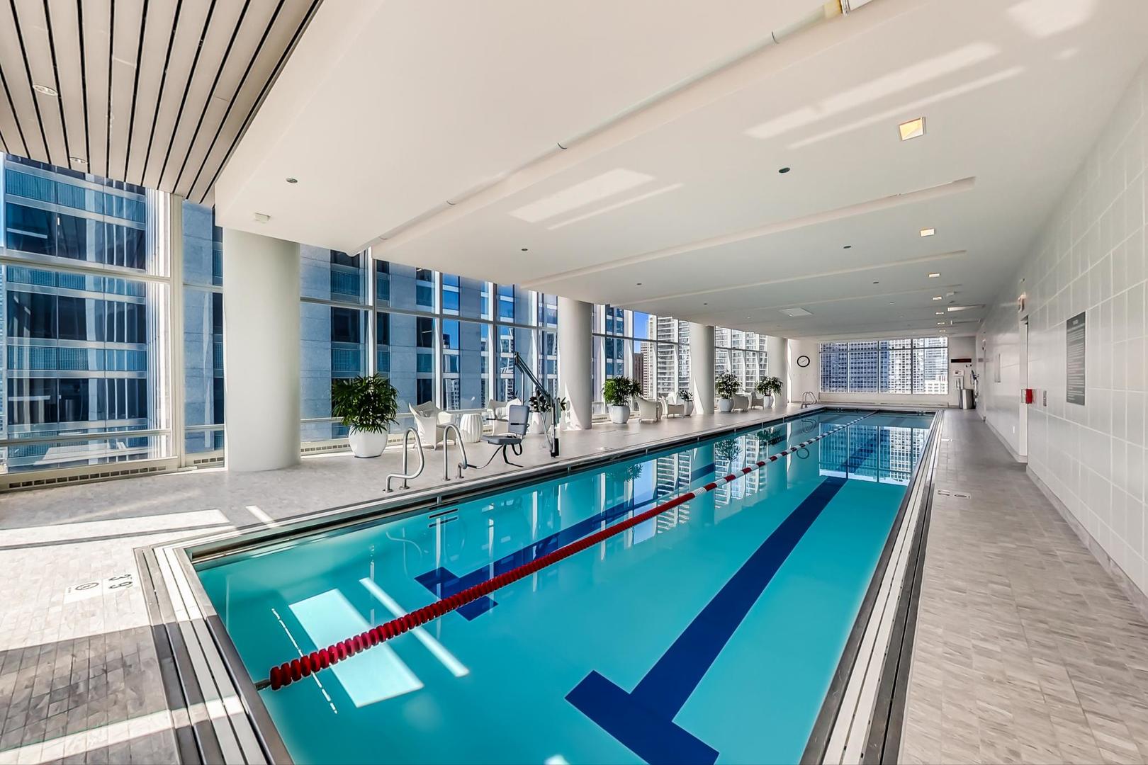 340 East Randolph Street, Unit 4901 Chicago, IL 60601 - Photo 36 of 50 a large space with lots of green space and large windows