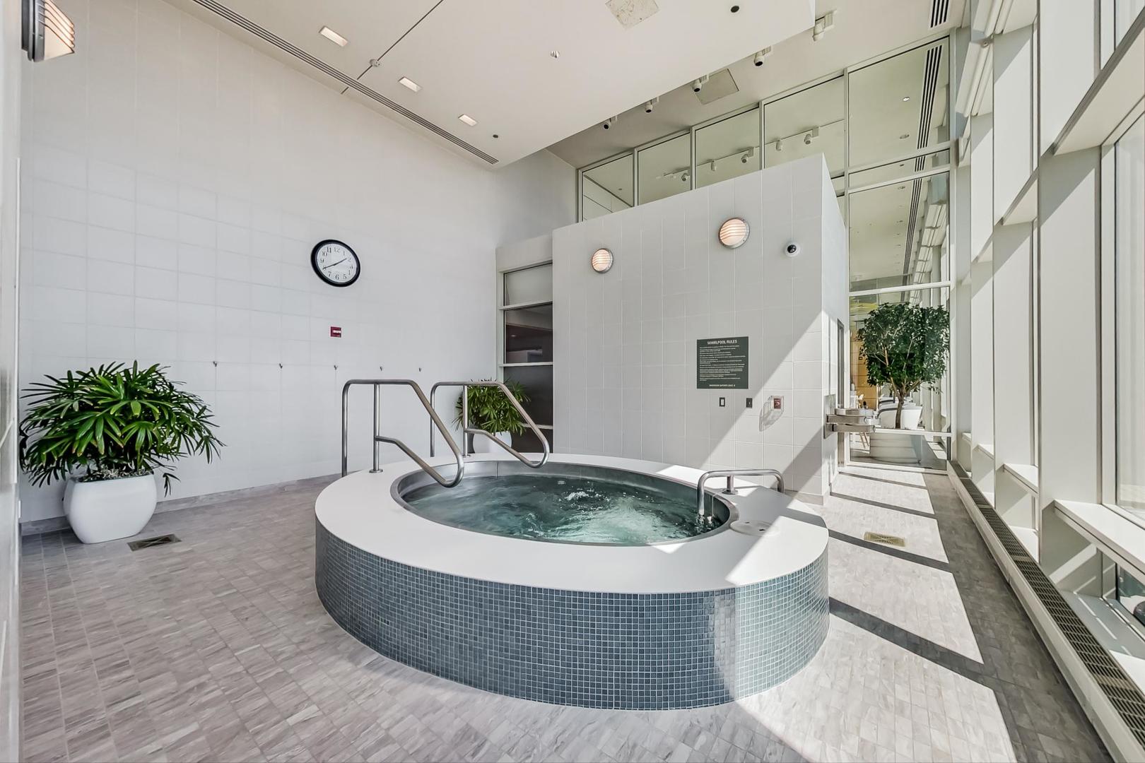 340 East Randolph Street, Unit 4901 Chicago, IL 60601 - Photo 37 of 50 a living room with furniture and flowers