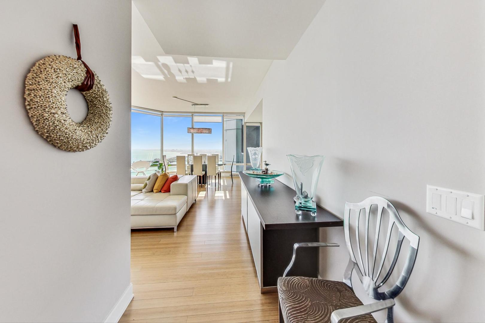 340 East Randolph Street, Unit 4901 Chicago, IL 60601 - Photo 4 of 50 a living room with furniture and a large window