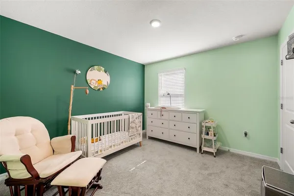 a bedroom with a bed and lamp