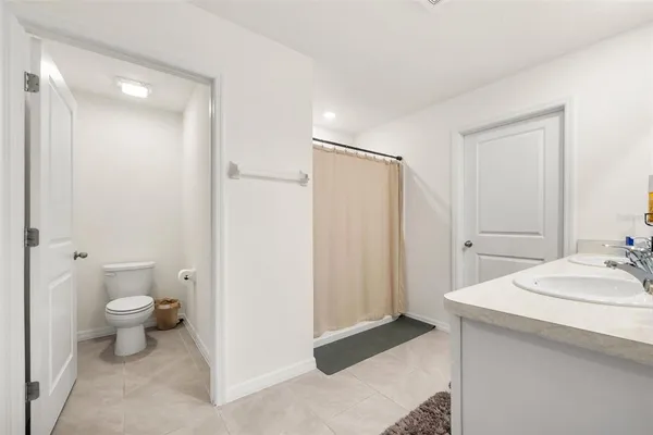 a white toilet sitting next to a bathtub