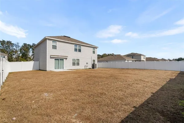a house with a big yard and large trees