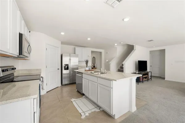 a kitchen with refrigerator and cabinets