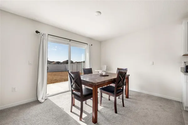 a view of a dining room with furniture and window