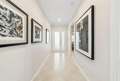 a view of a hallway with wooden floor and a large window