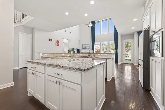 a view of a kitchen with a sink and wooden floor