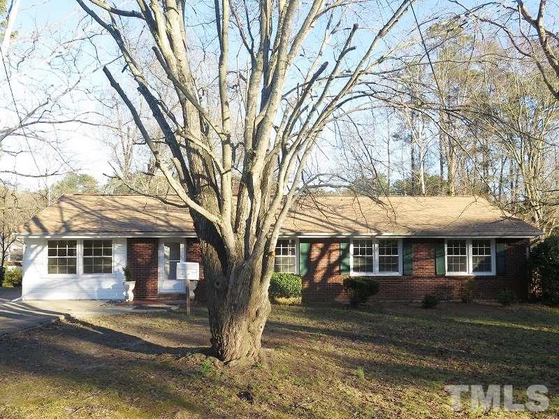711 St George Road Raleigh, NC 27610 - Photo 1 of 19 a front view of a house with a yard