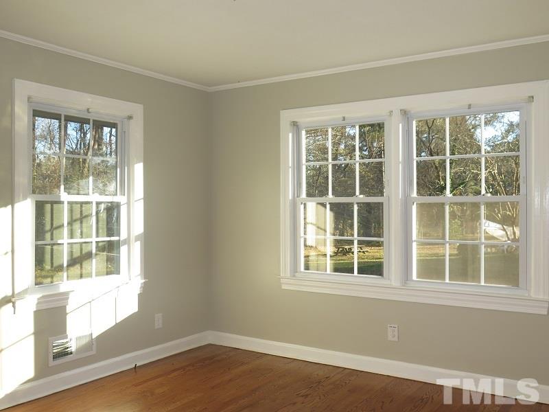 711 St George Road Raleigh, NC 27610 - Photo 14 of 19 a view of empty room with wooden floor and windows