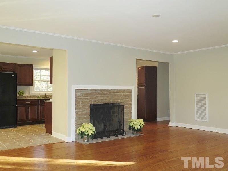 711 St George Road Raleigh, NC 27610 - Photo 3 of 19 a living room with furniture and a fireplace