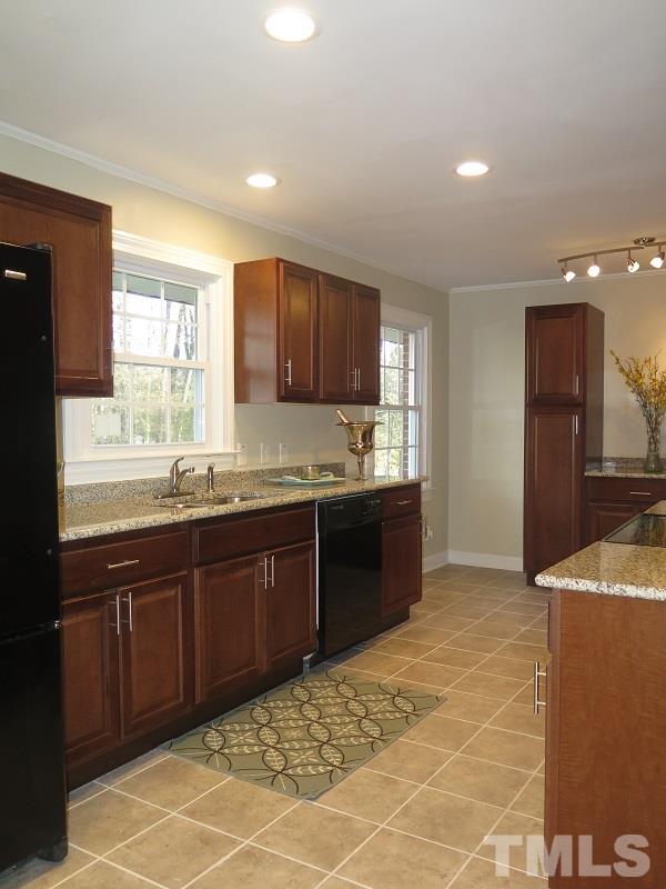 711 St George Road Raleigh, NC 27610 - Photo 6 of 19 a kitchen with stainless steel appliances granite countertop a sink stove and refrigerator