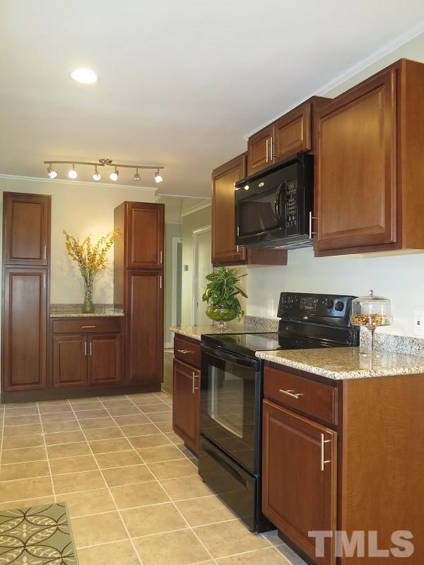 711 St George Road Raleigh, NC 27610 - Photo 7 of 19 a kitchen with stainless steel appliances granite countertop a stove a sink and a microwave