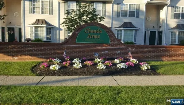a view of a bunch of flowers in front of house