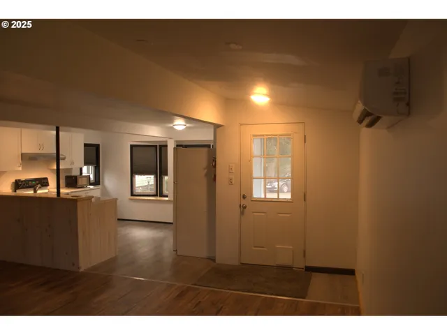 a kitchen with kitchen island sink stove and refrigerator