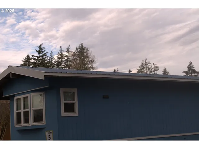 a view of house with backyard