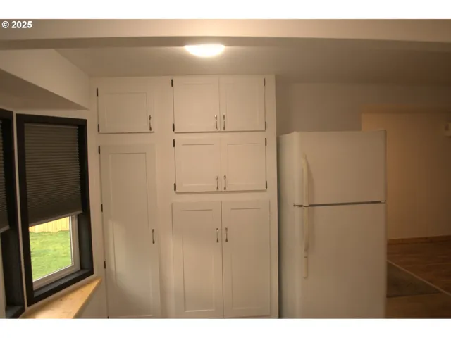 a kitchen with a sink a stove and cabinets