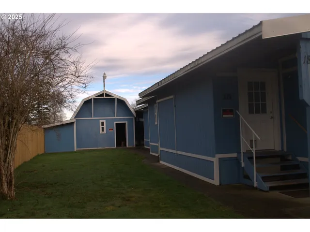 a backyard of a house with table and chairs