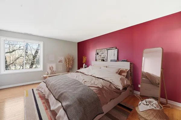 a bed sitting in a bedroom next to a window