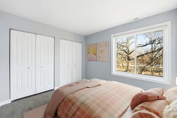 a bedroom with a bed and a window