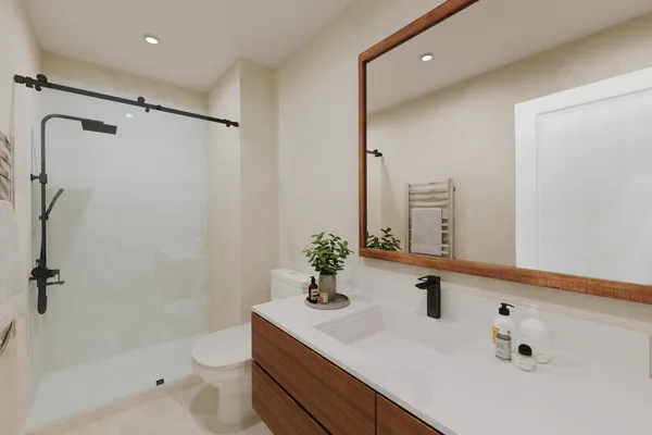 a bathroom with a sink toilet a mirror and shower