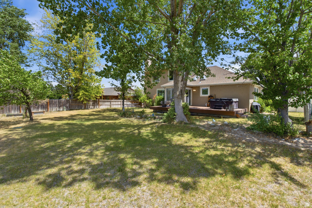 5788 Walden Ridge Drive Murray, UT 84123 - Photo 28 of 29 Expansive backyard featuring a large wood deck, mature trees, and a full privacy fence