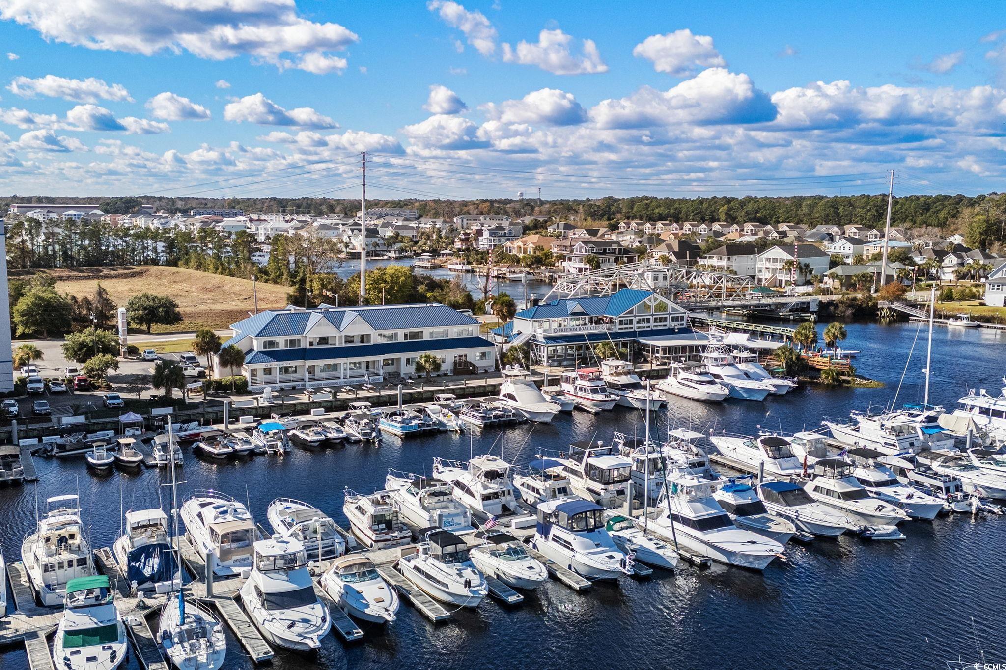 500 Eagle Way, Unit 6 Little River, SC 29566 - Photo 37 of 38 Drone / aerial view of a marina and a nearby body of water