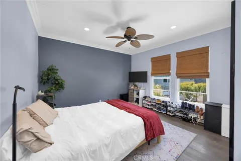 a bedroom with a large bed and a potted plant