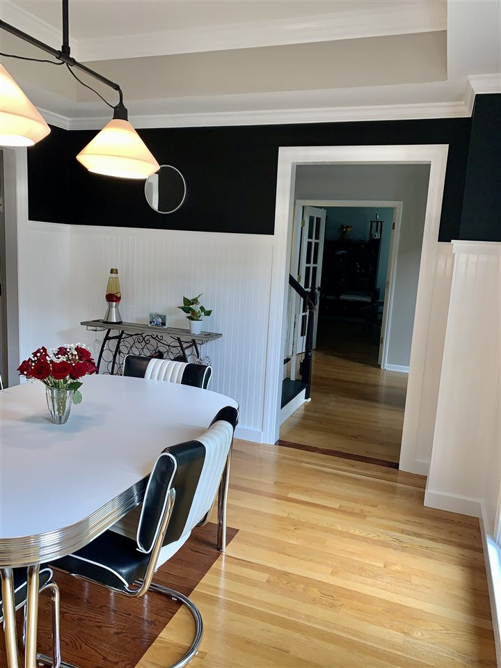 8512 Wheeling Drive Raleigh, NC 27615 - Photo 12 of 30 Freshly updated dining room in December 2020. Hardwoods, new lighting, extra tall, custom bead board. Light and bright and perfect for entertaining! Dining Room