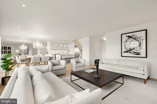 a living room with furniture and large windows