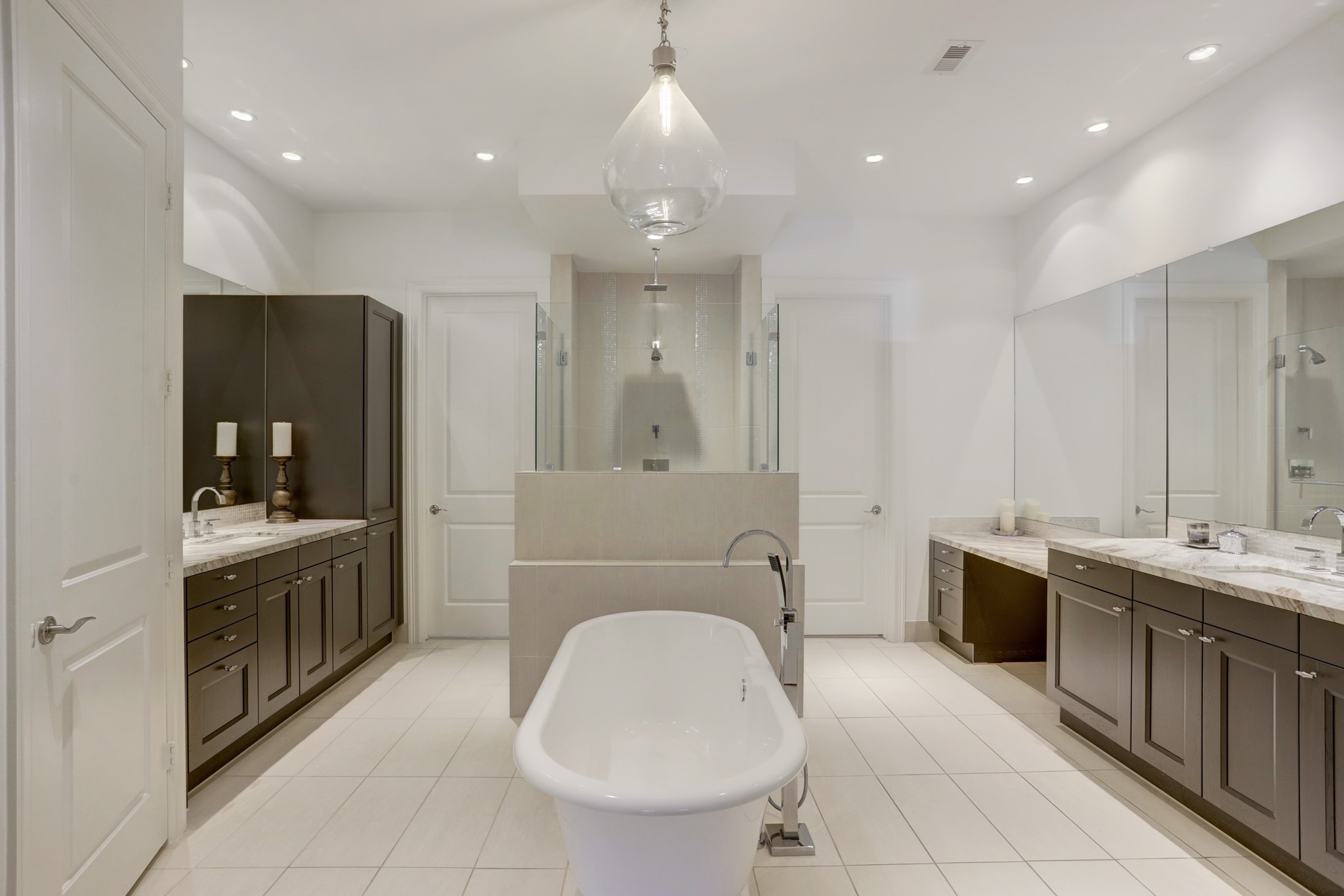 2221 Welch Street, Unit 201 Houston, TX 77019 - Photo 23 of 26 Large primary bathroom features separate vanities, soaking tub, and large walk-in shower. There is also 1 large walk-in closet with plenty of cabinet storage.