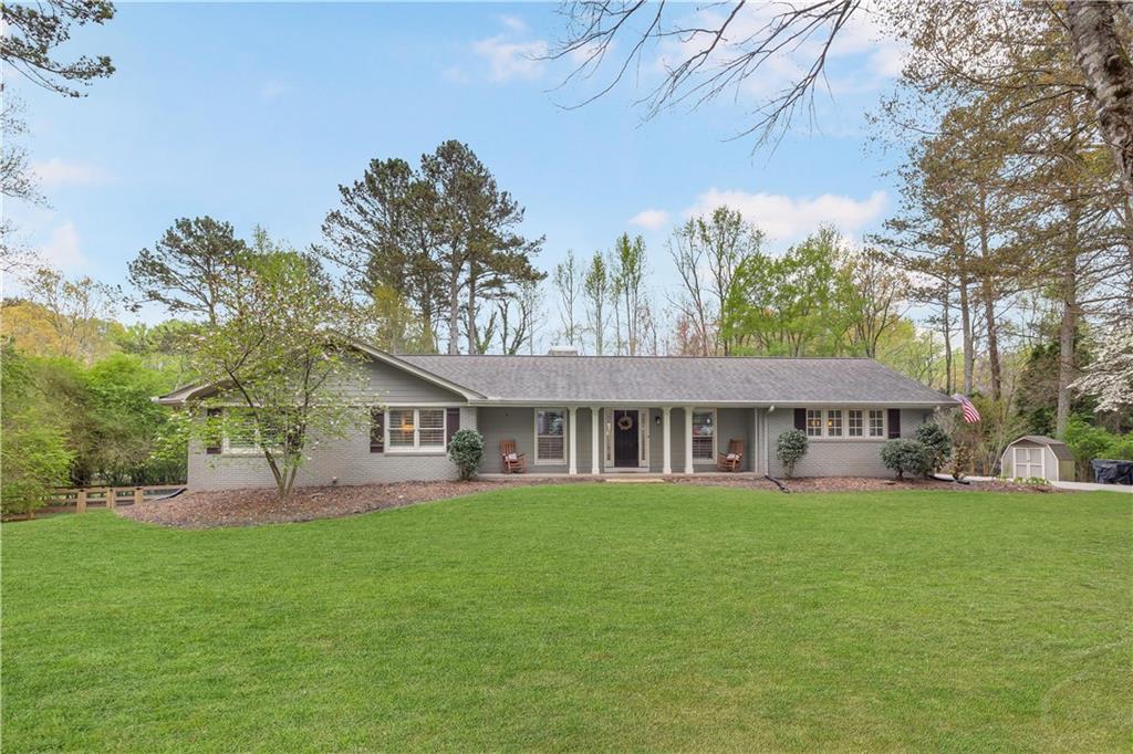 15565 South Thompson Road Alpharetta, GA 30004 - Photo 1 of 1 a house view with a sitting space and garden
