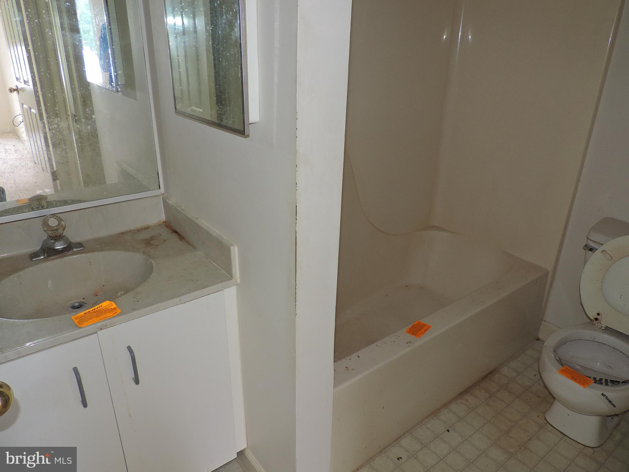 6708 Ridge Road, Unit 104 Baltimore, MD 21237 - Photo 10 of 11 a bathroom with a sink and a tub