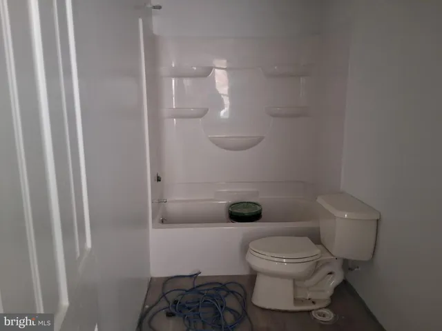 a bathroom with a toilet and a shower