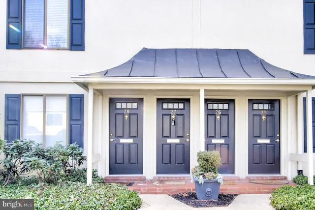a view of a house with potted plants
