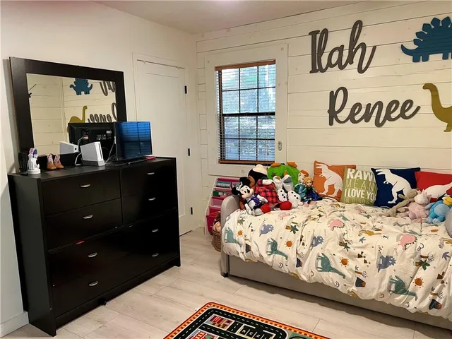 a bedroom with a bed and a dresser in it