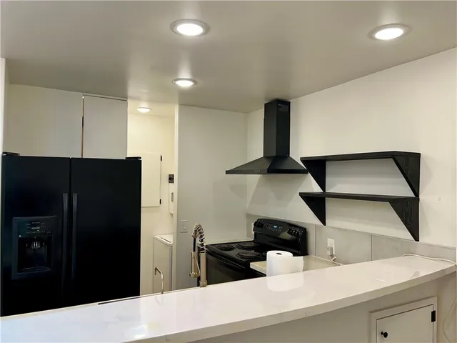 a kitchen with a refrigerator and a stove